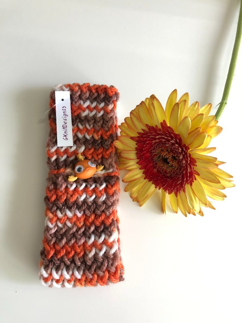 Hand knitted headband, ear warmer with little fish button